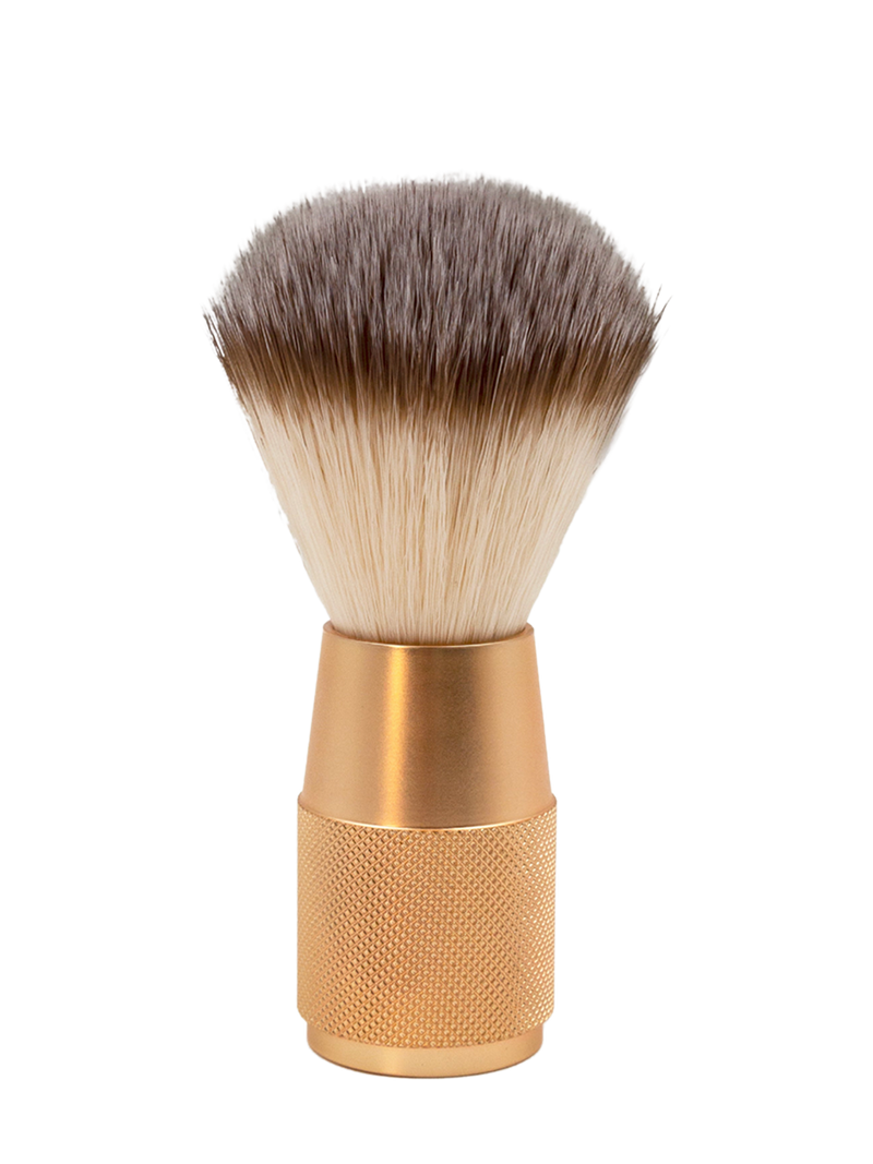 A photo of The Collective Rose Gold Shaving Brush standing upright.